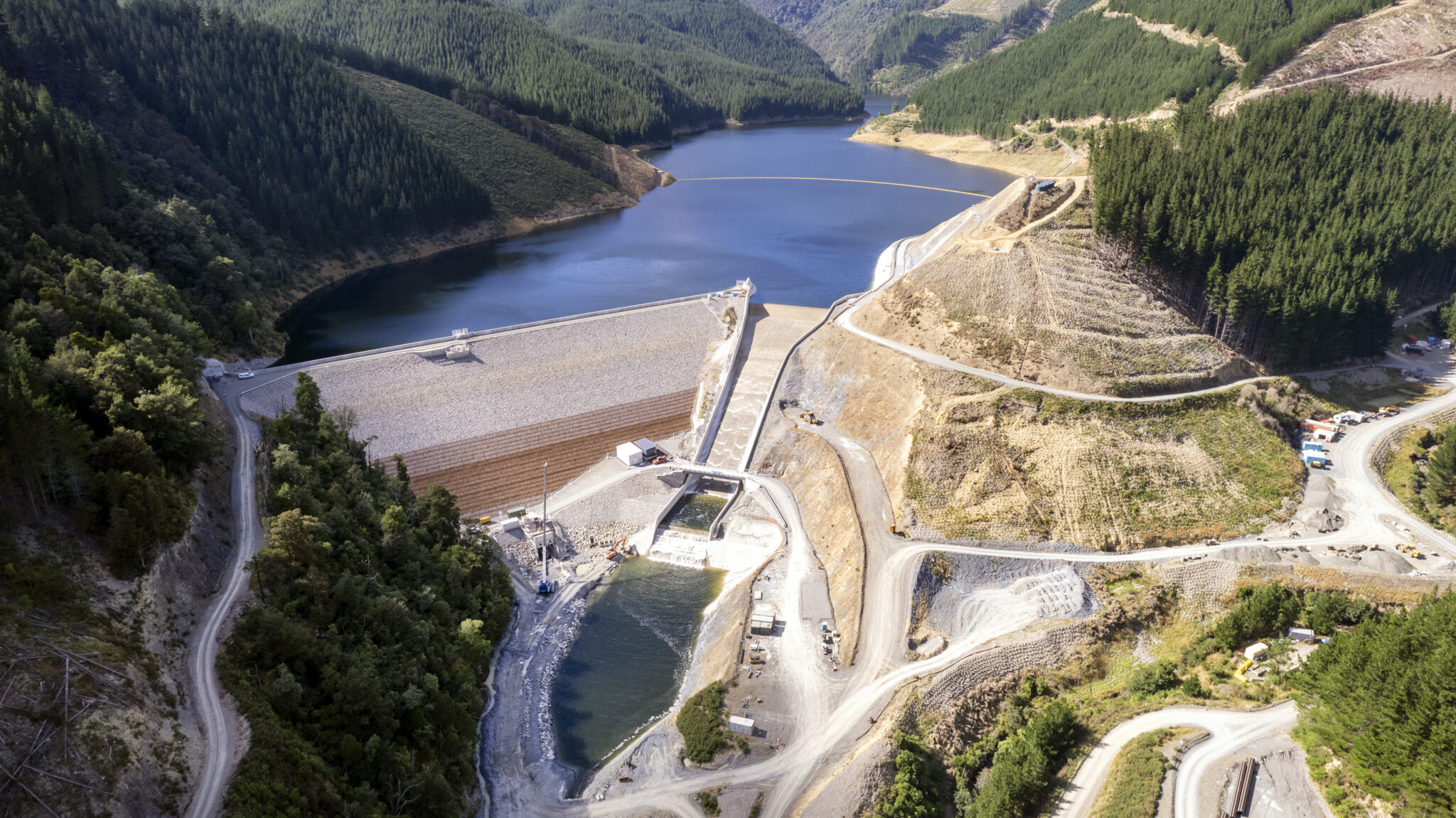 Overview-of-the-dam-looking-upstrea-water-flowing-over-spillway-2048x1151
